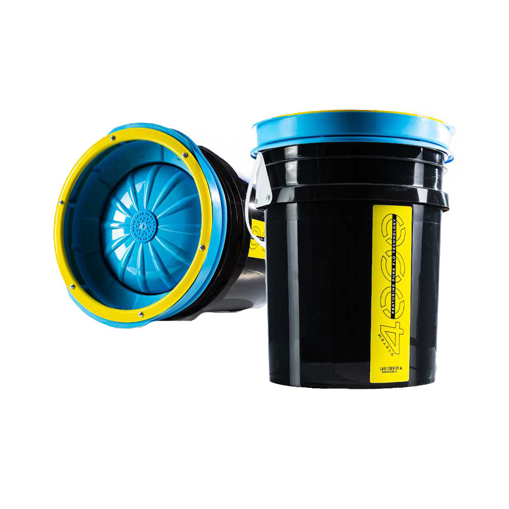 Lake Country System 4000 pad washer for cleaning car polishing pads, shown in use with water and foam on the pad.