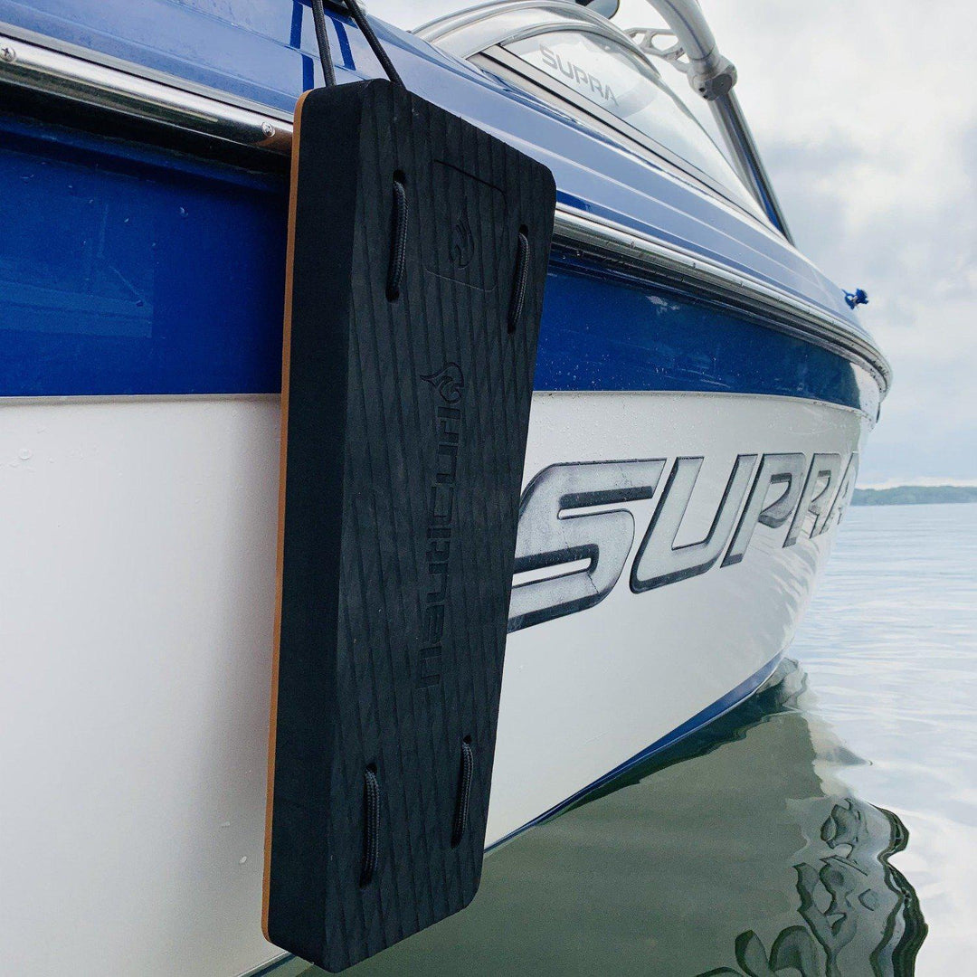 Black NautiFender flat boat fender from NautiCurl LLC, showing its modular design and durable construction for boat protection.