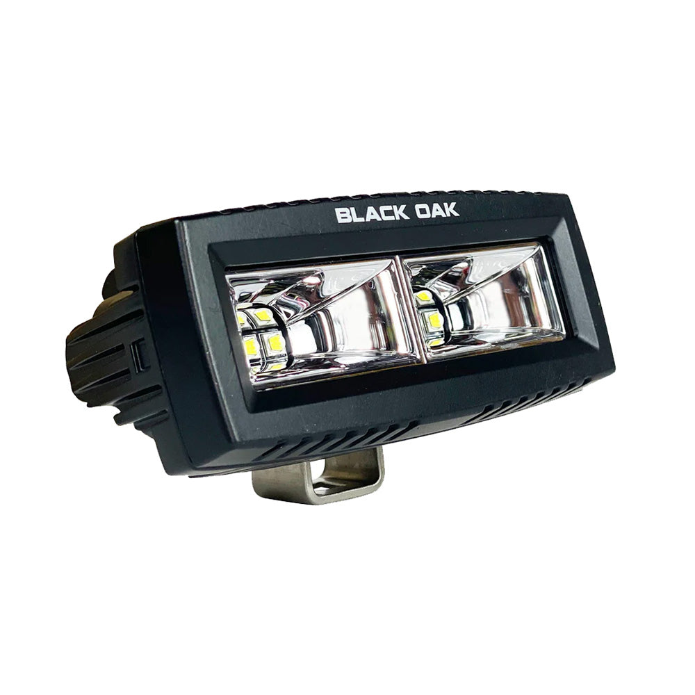 Black Oak LED 4-inch marine spreader flood light, scene illuminated, part of the Pro Series 3.0 in black, designed for boat lighting.