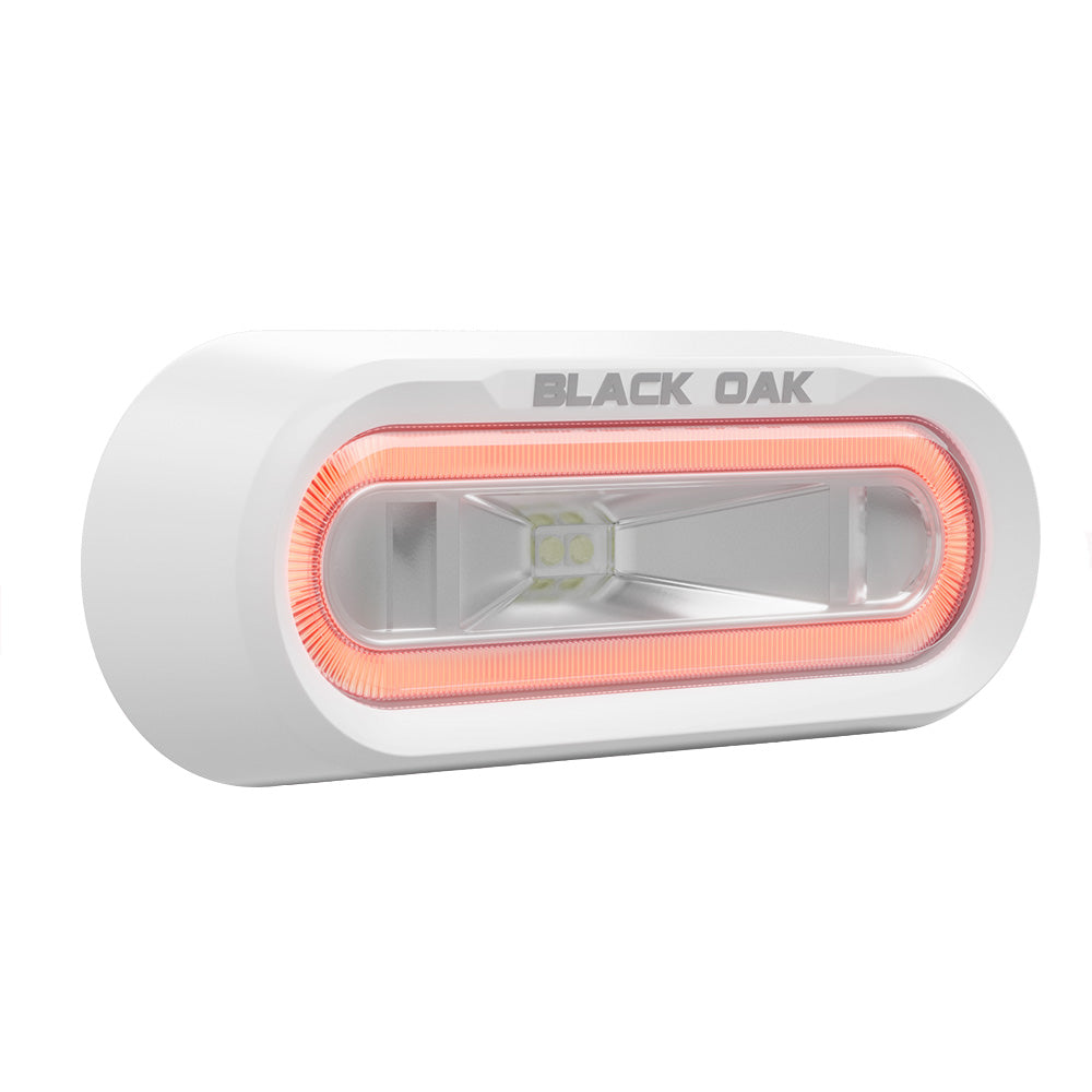 Black Oak LED underwater lighting with white housing and red LED, bracket mount, designed for off-road and spreader light applications.