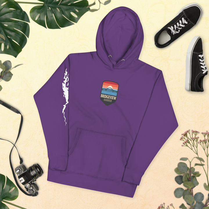 Black Bridgeview Harbour Midweight Hoodie, casual apparel with branded logo, shown on a hanger.