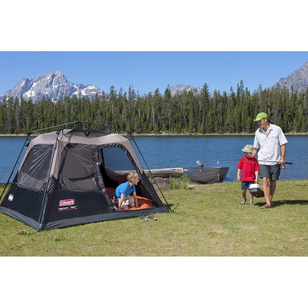 Coleman 4-person cabin camping tent in black, featuring quick instant setup with fabric walls and a rainfly for outdoor camping.