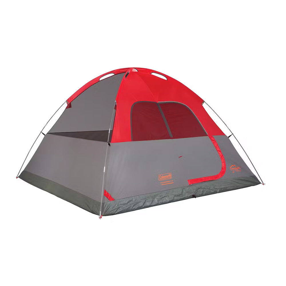 Coleman 6-Person Flatwoods II lightweight dome camping tent in red, set up outdoors with entrance and mesh windows visible.