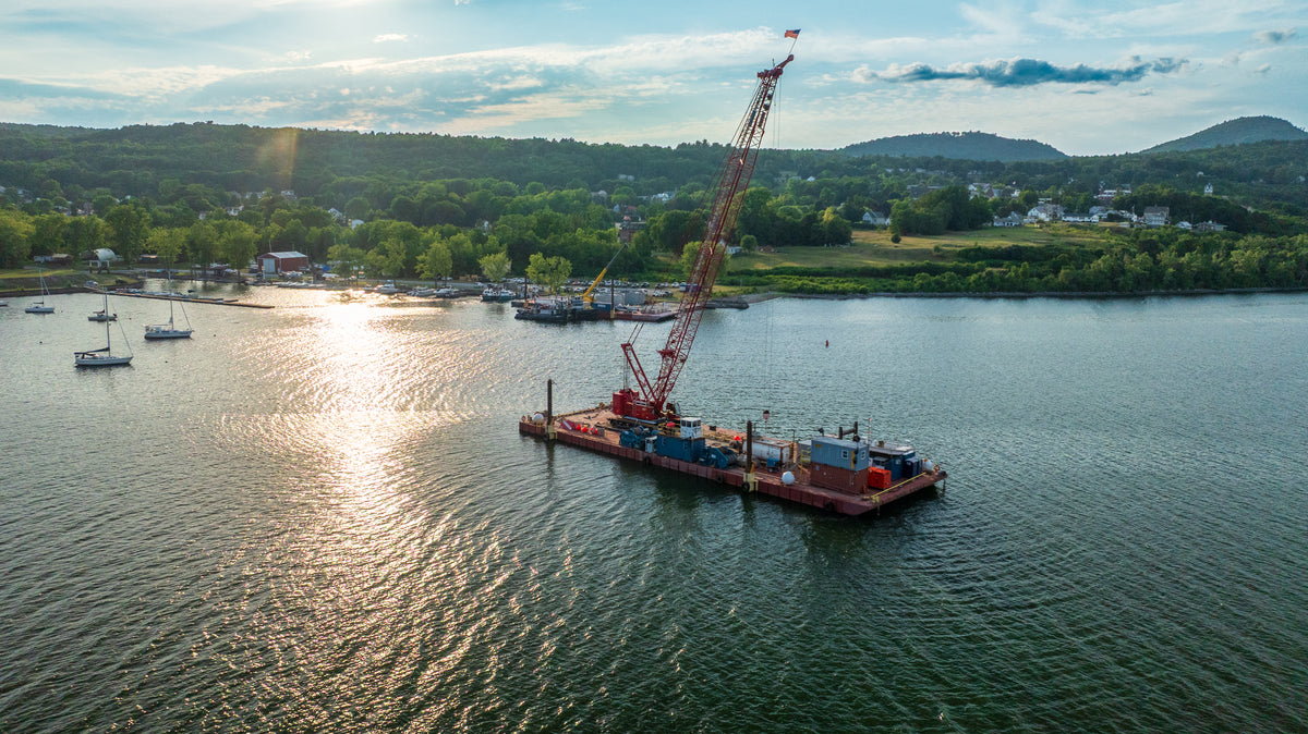 Barge with crane on a lake champlain with a scenic background