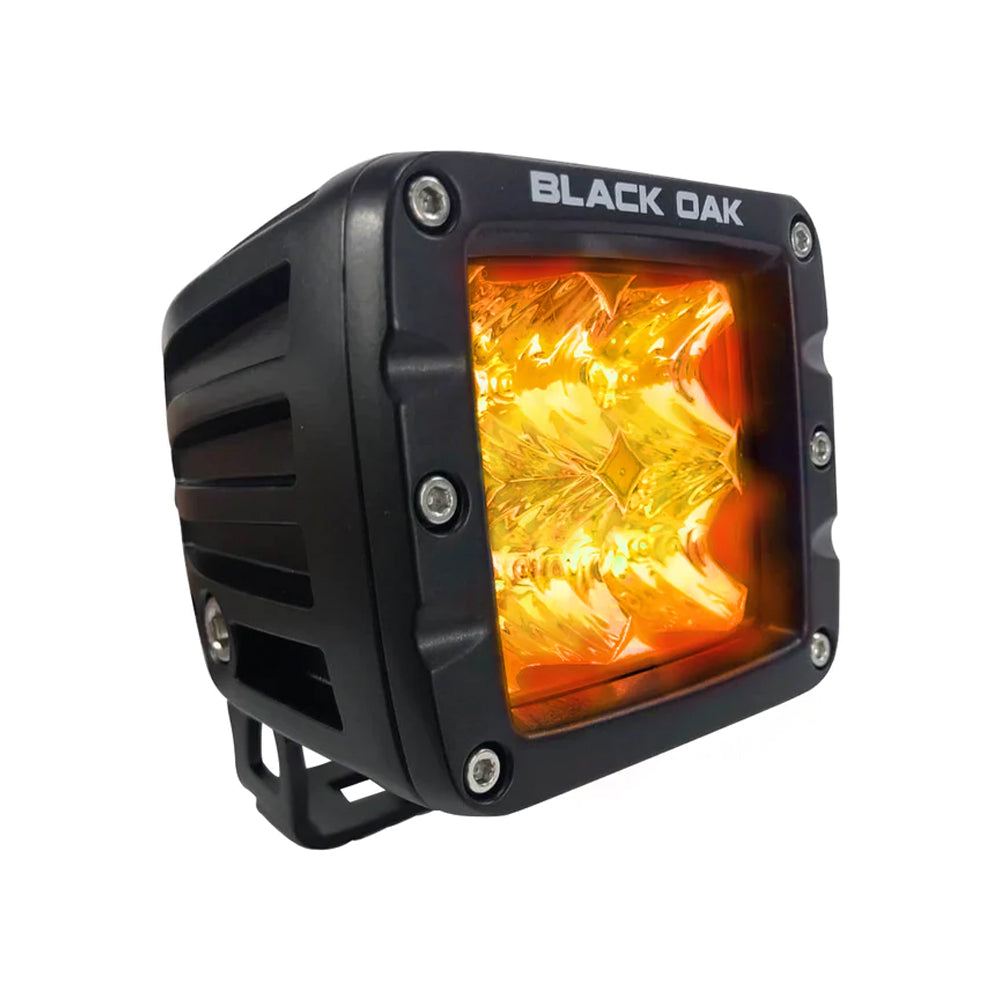 Black Oak LED 2-inch Amber LED pod light with flood optics and black housing, part of the Pro Series 3.0 for versatile outdoor lighting.