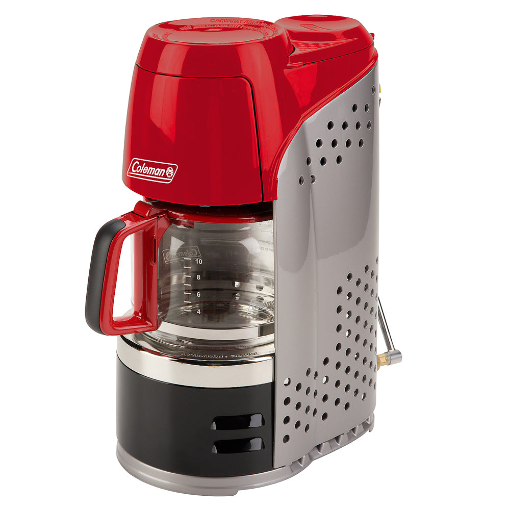 Coleman 10-Cup Portable Propane Camping Coffeemaker brewing coffee outdoors on a camping stove.