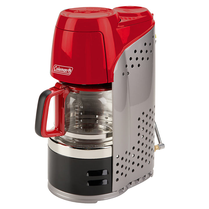 Coleman 10-Cup Portable Propane Camping Coffeemaker brewing coffee outdoors on a camping stove.