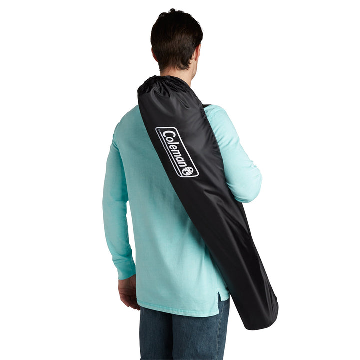 Coleman Cooler Quad Camping Chair in black with built-in cooler and armrests, ideal for outdoor camping and relaxing.