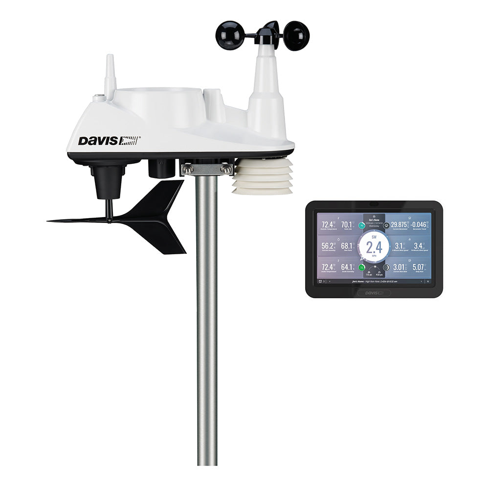 Wireless Davis Vantage Vue weather station with WeatherLink console, displaying outdoor sensors and data readouts in a home weather setup.