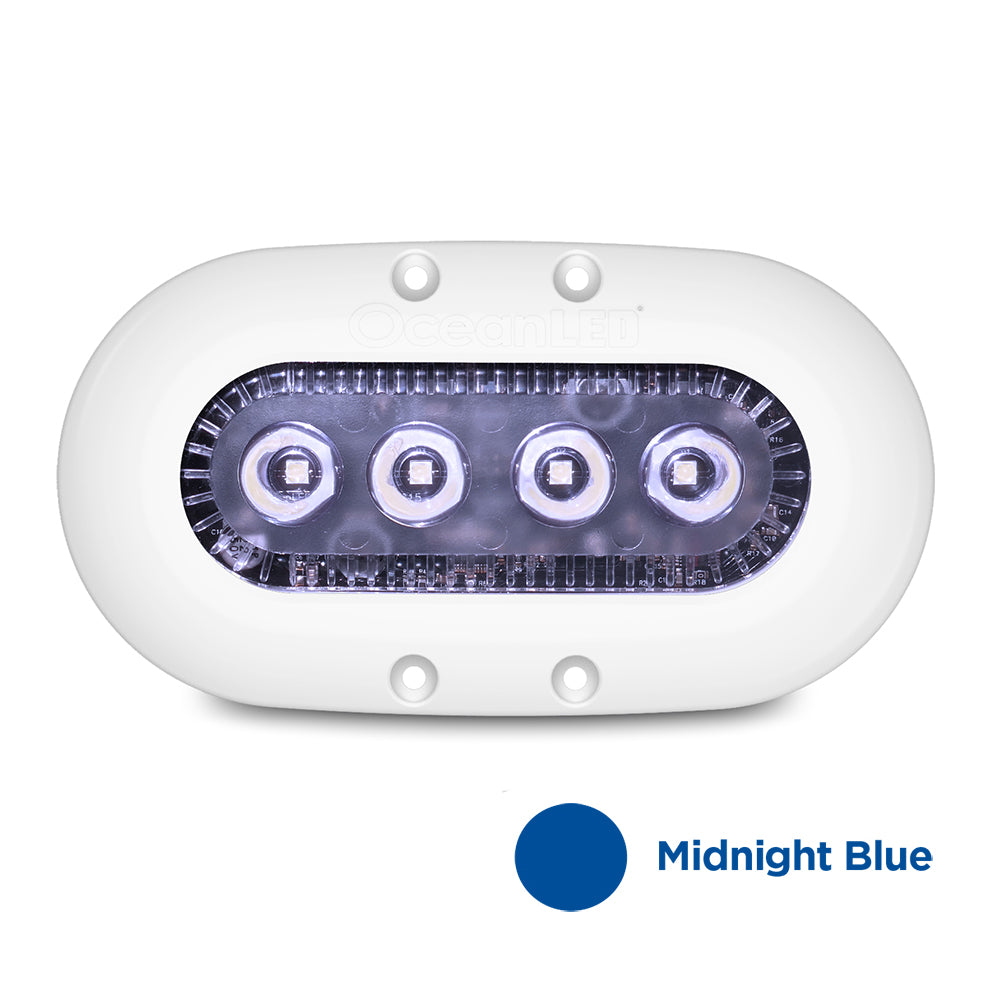 OceanLED X-Series X4 underwater lighting with midnight blue LEDs, showing the sleek underwater light fixture installed on a boat.