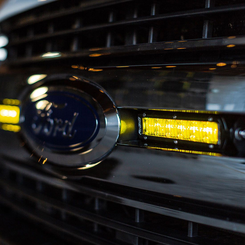 Rigid Industries 6-inch SR-Series SAE fog light bar in black with yellow light, designed for off-road and vehicle lighting.