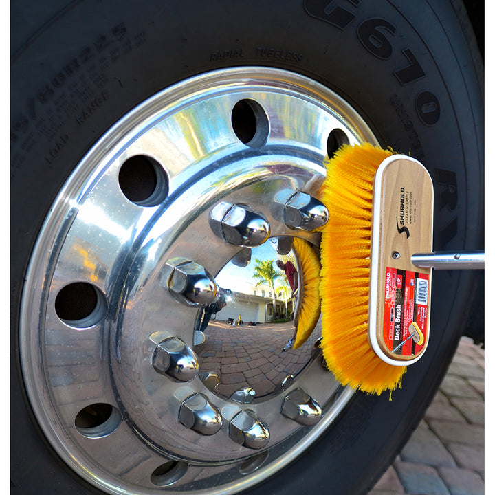 Shurhold 10-inch polystyrene medium bristle deck brush for cleaning boats and decks, with sturdy handle and durable bristles.